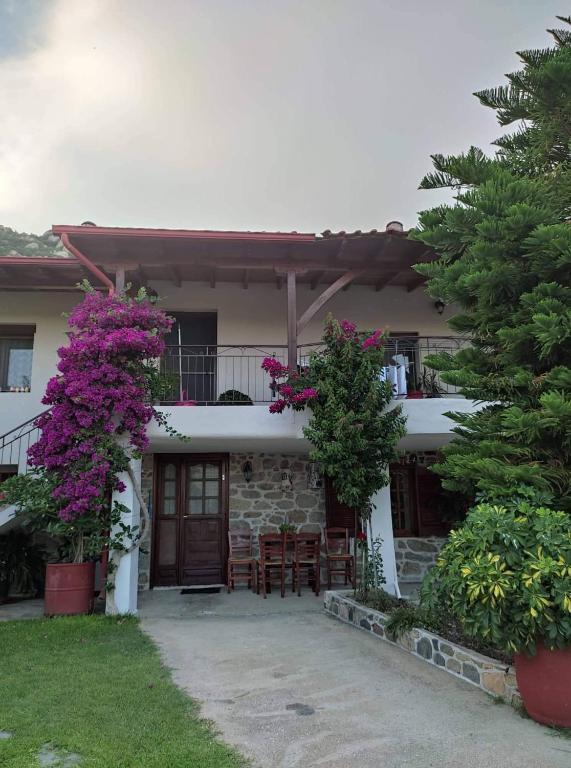The stone facade of Sweet Home with bougainvillea